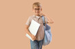 © Pixel-Shot - Little schoolboy with laptop on beige background