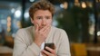 © forenna - A man checking his phone at a café and suddenly covering his mouth in disbelief after reading life-changing news — digital surprise moment, authentic emotional expression, and modern communication