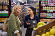 © Rido - Happy mature woman talking to store manager at supermarket