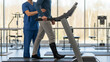 © Muhammad - Physical therapist assisting patient with leg brace on treadmill for rehabilitation, showcasing recovery and care in a modern clinic setting