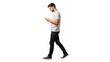 © Felippe Lopes - Young man walking while looking down at his mobile phone isolated on transparent background