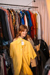 © Big Shot Theory - Bright Yellow Shirt: Fashion Enthusiast Browsing Vintage Clothing Rack