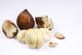Fresh peeled salak fruit with brown scaly skin on white background