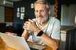 © Geber86 - Mature man smiling during video call at home office