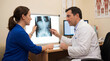 © Sara_P - Doctor Discussing X-Ray Results with Patient in Medical Consultation Room
