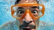© liliyabatyrova - With a pair of bright orange goggles, a swimmer peers through the clear blue water, eyes wide with wonder at the aquatic scenes around him. Bubbles dance in the sunlight above