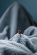 © Alexander - A figurine of a miniature mountain climber, set on a soft fleece surface that mimics a snow-covered landscape