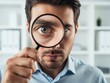 © Habiba - Closeup portrait of a serious businessman looking intensely through a magnifying glass held up to his eye, suggesting inspection or scrutiny