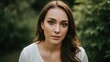 © arsyi_06 - A young woman with long brown hair in a white top looks directly at the camera outdoors