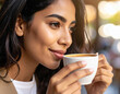 © ryoutan - Smiling Woman Enjoying Coffee Break Outdoors in Sunlight