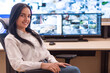 © as-artmedia - Smiling Female Security Officer at Surveillance Desk