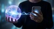 © HusnaAkther - Person holding glowing orb and smartphone with energy connection concept