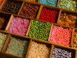 © Bangkok Click Studio - Vibrant collection multicolor craft beads neatly arrange in wooden organizer boxes compartment showcases unique textures hues, handcrafted creating charming slow fashion bracelets inspiring display.