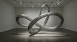 © Hatma - Metal mobius strip sculpture in white gallery track lights illuminate the artwork
