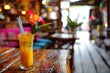 © Artsaba Family - Refresh yourself with a vibrant cocktail adorned with a flower, creating a refreshing and visually appealing moment to enjoy at a restaurant or bar