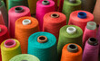 © Kate - Colorful sewing thread spools arranged in a vibrant composition. Bright yarn cones in various shades including red, orange, green, turquoise, pink, and purple