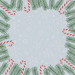 © MDJALAL - Festive christmas frame with green fir branches and red and white candy canes on a light blue background