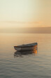 © Adam Rhodes - Small boat on a calm lake