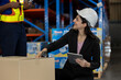 © eakgrungenerd - Female warehouse supervisor scanning package barcode with handheld scanner while using tablet for inventory tracking. Concept of smart logistics, digital warehouse management and supply chain