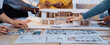 © InfiniteFlow - A dynamic scene of a collaborative design process featuring hands engaged with an architectural model and sketches, showcasing creativity and teamwork in a modern workspace. SACTR