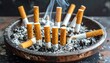 © Bareng - A close-up shows a well-used ashtray filled with cigarette butts, ash, and curling wisps of smoke