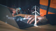© PRIM - Engineer hands typing on laptop with futuristic wind turbine hologram overlay. Sustainable renewable energy technology and smart grid data analysis concept for modern eco friendly industry.