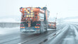 © Sabrewolf - Snow plow sprinkles highway with road salt in freezing weather.