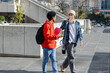 © Wavebreak Media - Diverse male students walking across plaza sipping coffee, carrying notebooks smartphones backpacks