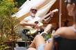 © romaset - A man plays guitar for a woman near a cozy tent at a glamping site.