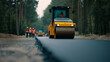 © Curioso.Photography - Road roller compacting freshly laid asphalt during road construction work.