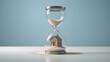 © Fathia A.M. - Miniature House Inside Hourglass with Falling Sand, Mortgage and Time Concept