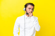 © luismolinero - Telemarketer caucasian man working with a headset isolated on yellow background having doubts and with confuse face expression