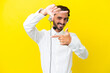 © luismolinero - Telemarketer caucasian man working with a headset isolated on yellow background focusing face. Framing symbol