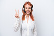 © luismolinero - Telemarketer Russian girl working with a headset isolated on white background smiling and showing victory sign