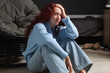 © Tatyana Gladskih - Sad Lonely and Depressed teenage sitting on floor near couch at home