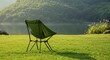 © Kurma - Serene outdoor scene featuring a solitary green folding chair on a vibrant green lawn overlooking a lake