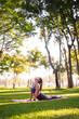© Pichsakul - Asian adult woman performing yoga cobra pose stretching body flexibility wellbeing beautiful sunny park fitness health nature peaceful mindful exercise healthy lifestyle
