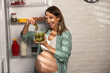 © milanmarkovic78 - Pregnant Woman Enjoying Pickles From Fridge At Home
