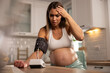 © milanmarkovic78 - Worried Pregnant Woman Measuring Blood Pressure
