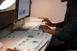 © Crystal - Man crunching numbers and analyzing charts on a computer in a dimly lit office, demonstrating dedication and overtime work