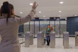 © Jelena - Traveler waving goodbye to friend at transit hub