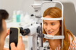 © Moon Safari - Close-up of ophthalmologist photographing female patient during eye checkup with slit lamp at clinic
