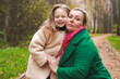 © velirina - Cuddling mother with daughter in park. Smiling family portrait shows love, affection, support. Close bonding supports childhood happiness, motherhood care, trust, safe relationship, outdoor lifestyle.