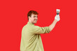 © Pixel-Shot - Young man with putty knife on red background
