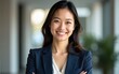 © wang - A woman in a business suit is smiling and posing for a photo. High quality