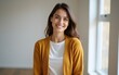 © li - Lifestyle portrait photography of a grinning woman in her 30s wearing a chic cardigan against a minimalist or empty room background. High quality