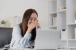 © itchaznong - Office Syndrome: Woman with stressed expression at her computer desk
