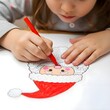 © Vipula - Macro close-up of a young girl’s tiny hands drawing Santa on white paper with bright crayons, focusing on Santa’s red hat, fluffy beard, and playful festive details.