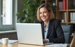 © lan - Happy mature business woman entrepreneur in office using laptop at work, smiling professional middle aged 40 years old female. High quality
