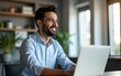 © lin - Smiling mature business man executive wearing shirt sitting at desk using laptop. Happy busy professional middle aged Indian businessman investor working on computer looking away in office. Copy space